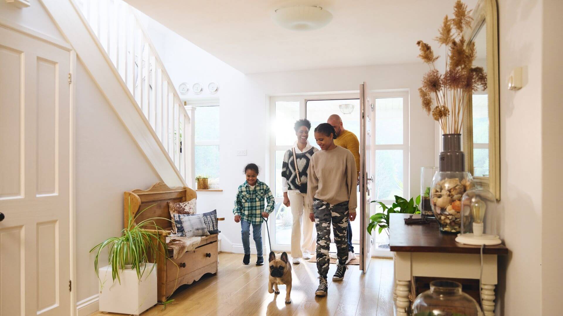family walking into a house
