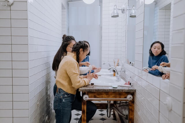 teenagers using hot water in bathroom