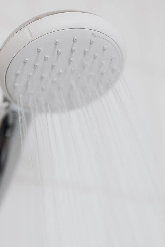 A shower head spraying hot water