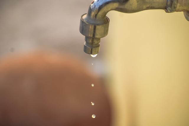 a stainless steel faucet leaking hot water