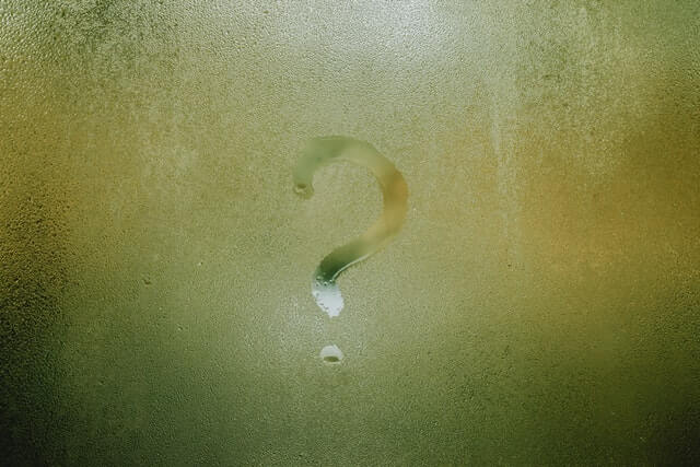 question mark drawn in shower hot water steam on glass