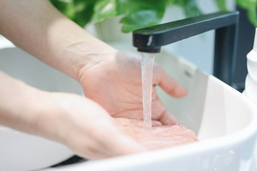 Hands washing in sink