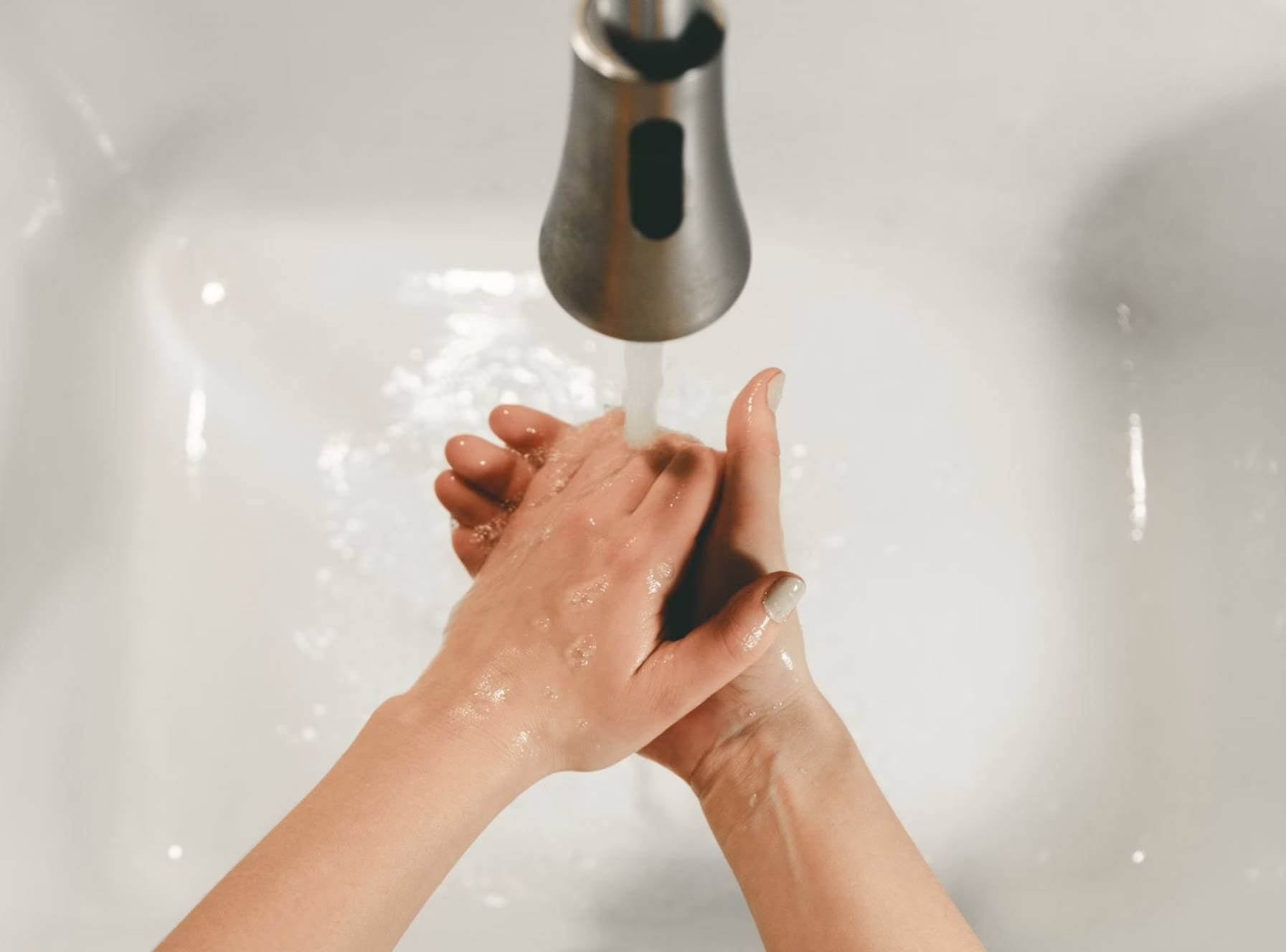 washing hands under tap