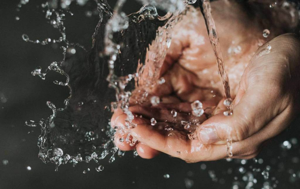 washing hands under tap