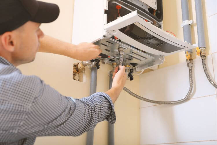 Technician installing a hot water system