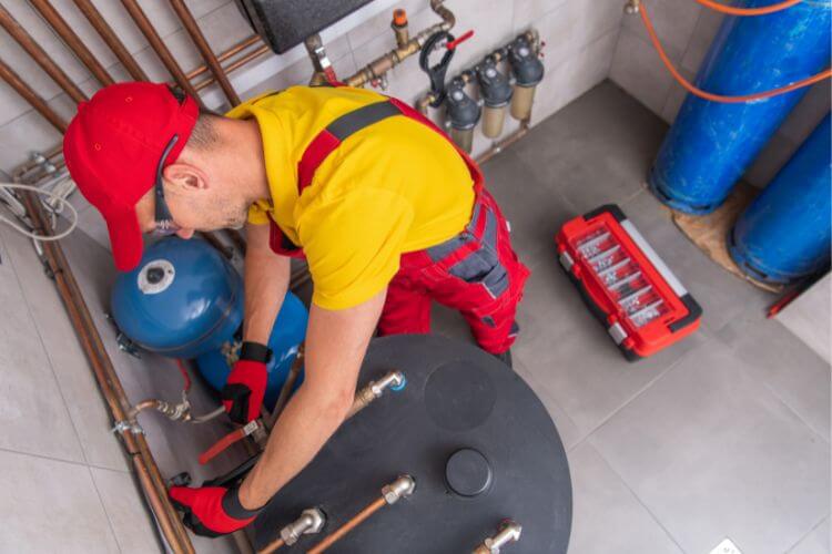 man repairing a hot water system