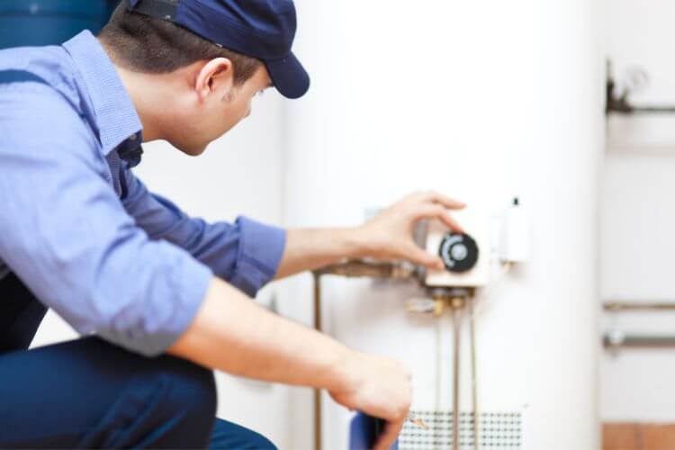 Technician setting the appropriate temperature on the hot water system