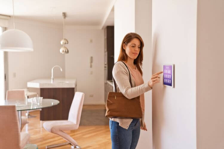 Lady using digital touch pad in a smart home