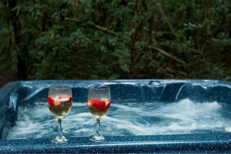 two wine glasses on a spa bath