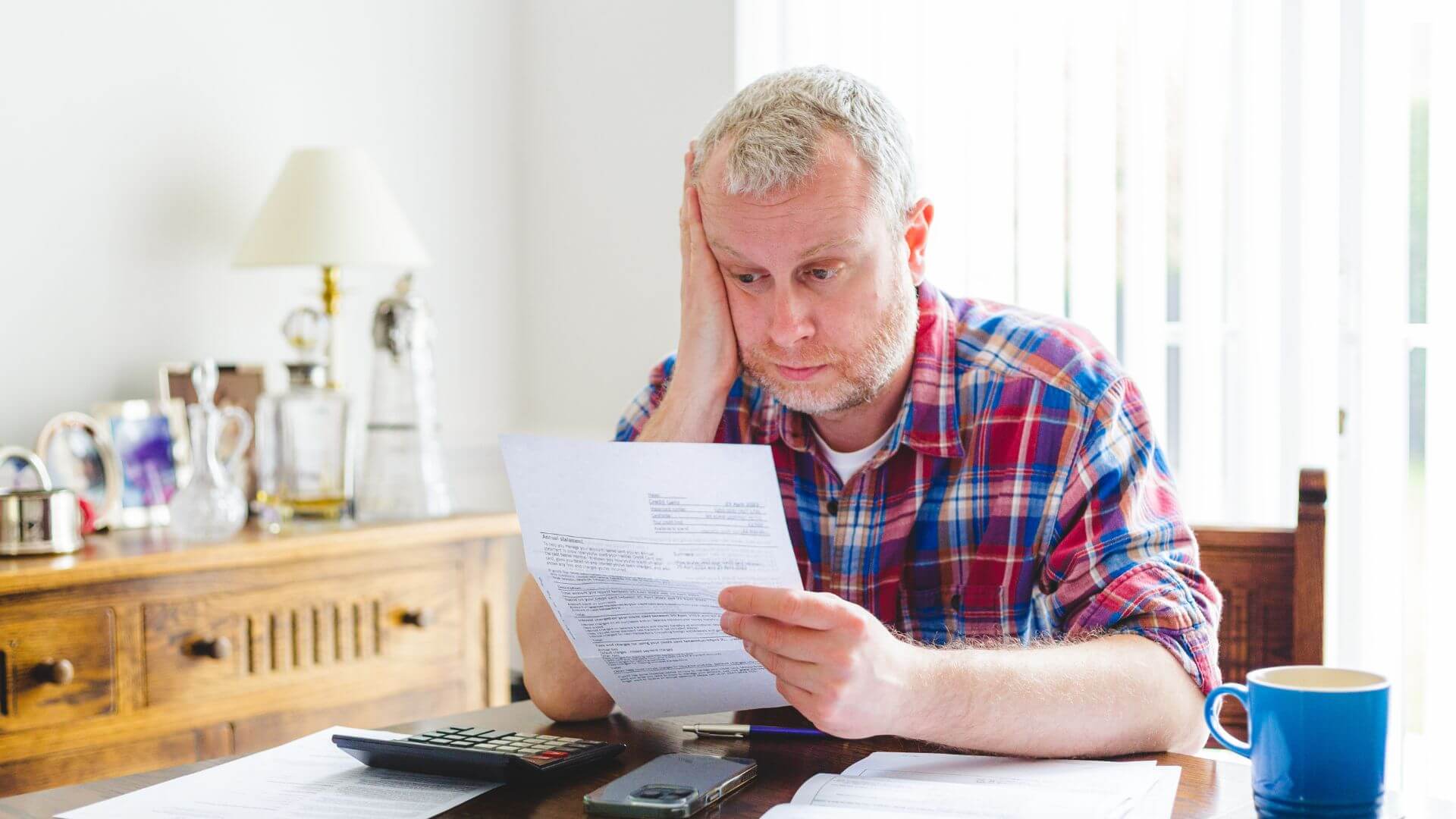 man reviewing higher energy bill